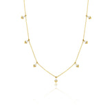 yellow gold chevron drop necklace on white background