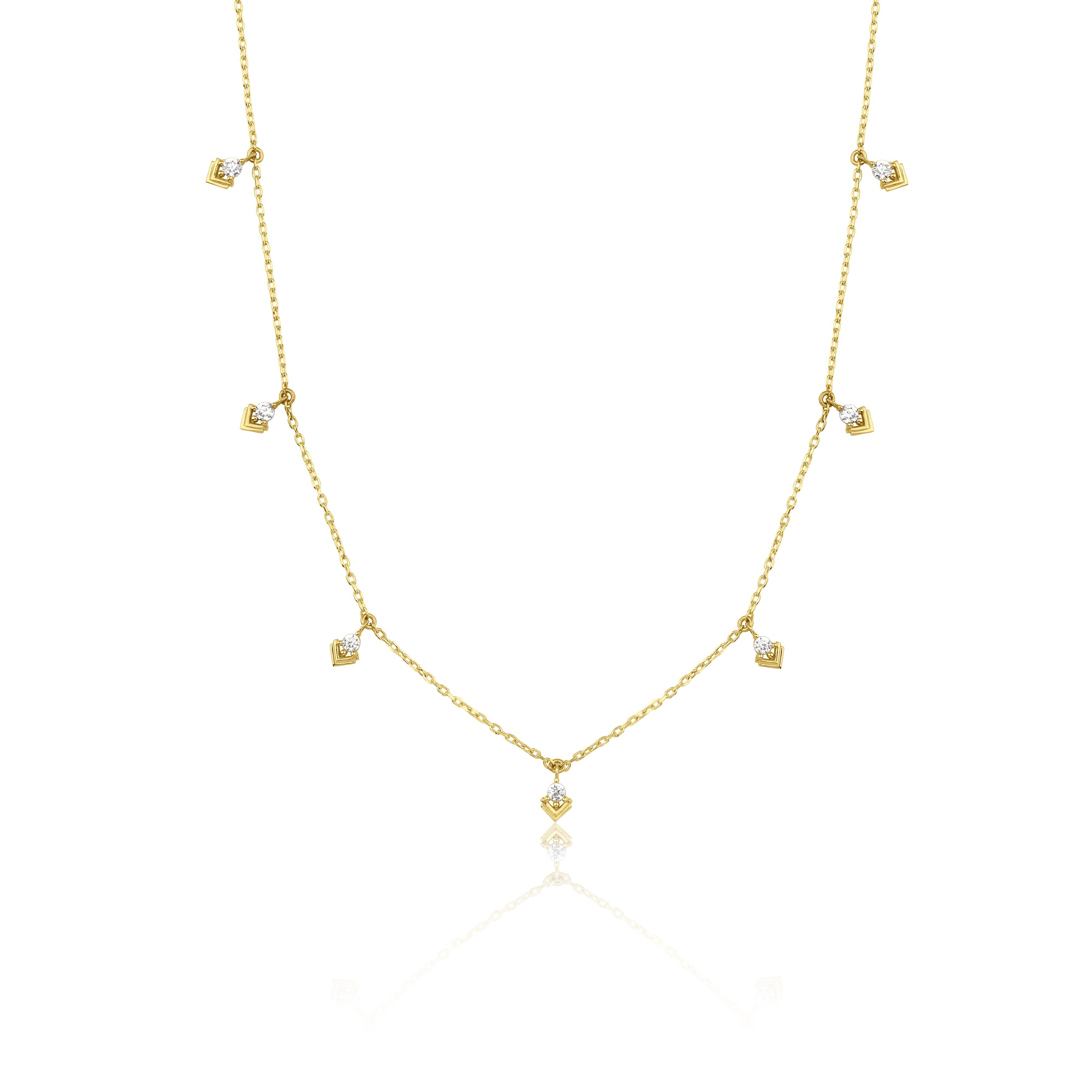 yellow gold chevron drop necklace on white background