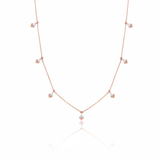 rose gold chevron drop necklace on white background