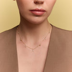 model wearing the gold chevron drop necklace