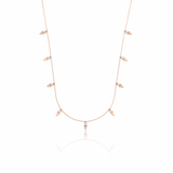rose gold triangle charm necklace on white background