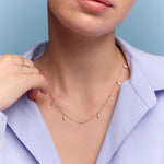 model wearing the gold triangle charm necklace