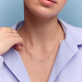 model wearing the gold triangle charm necklace