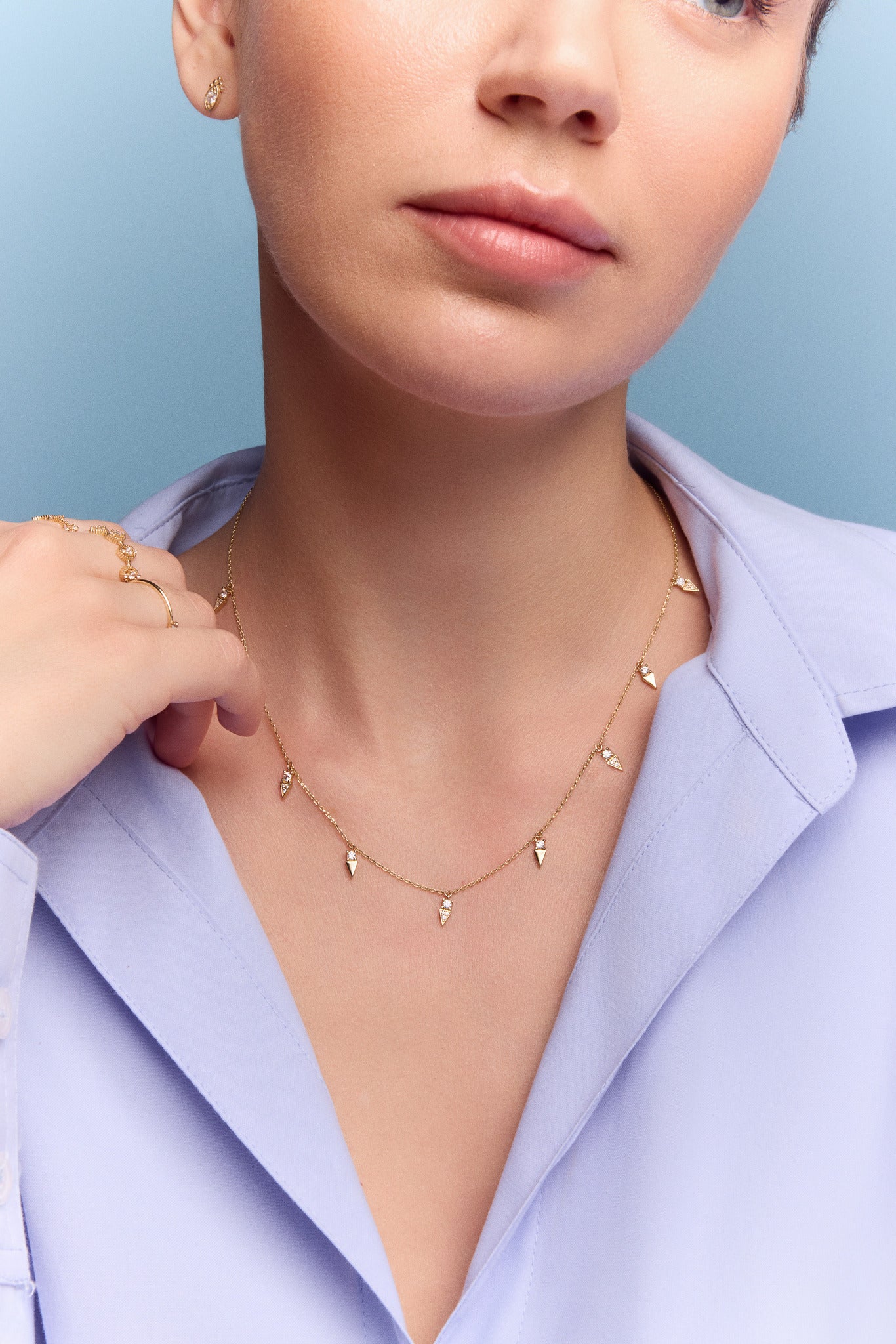 model wearing the gold triangle charm necklace