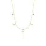 yellow gold starburst charm necklace with compass star pendant on white background