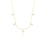 yellow gold starburst charm necklace with compass star pendant on white background