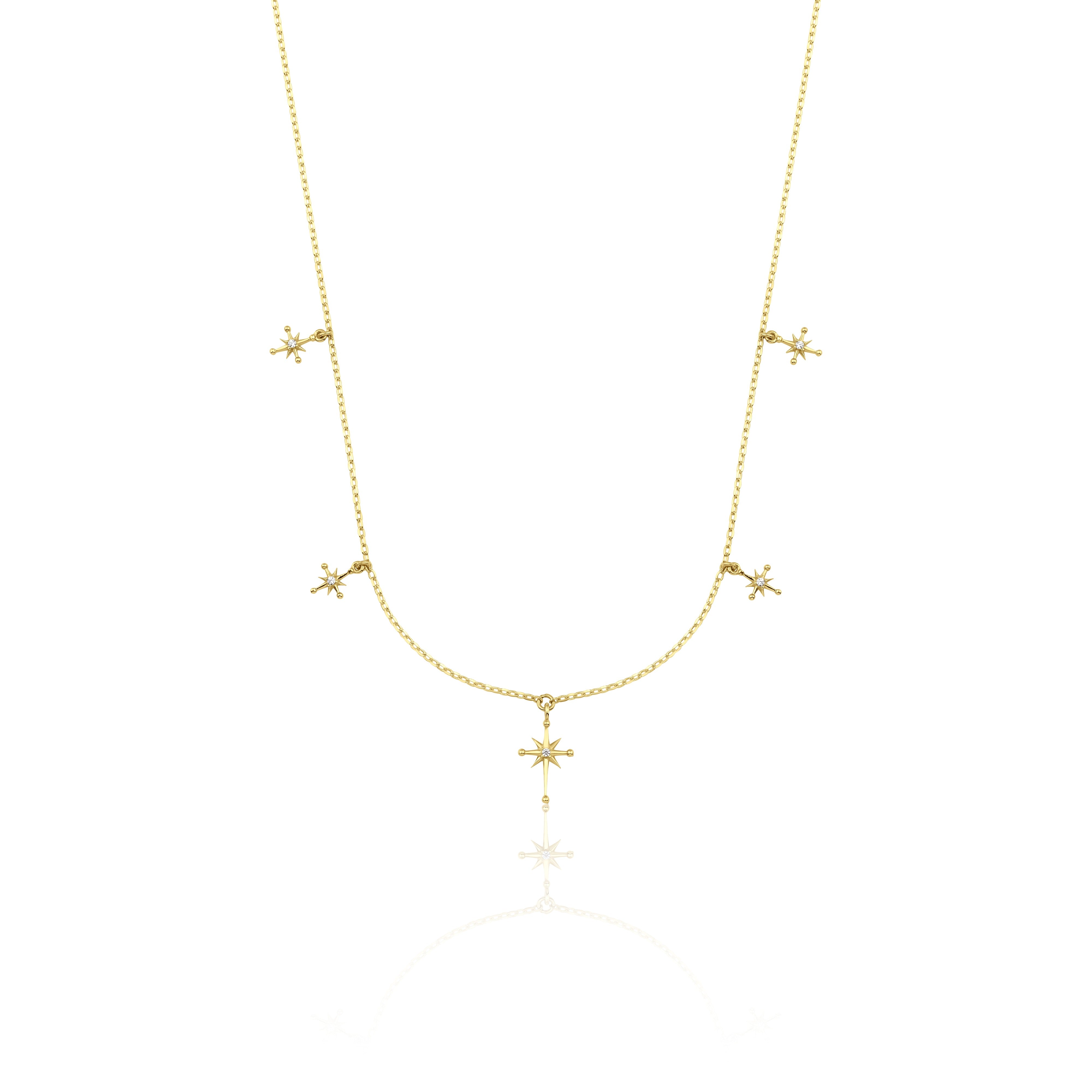 yellow gold starburst charm necklace with compass star pendant on white background