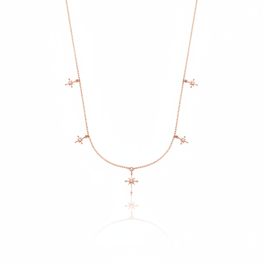 rose gold starburst charm necklace with compass star pendant on white background