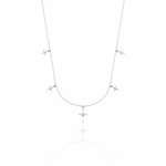 white gold starburst charm necklace with compass star pendant on white background
