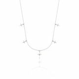 white gold starburst charm necklace with compass star pendant on white background
