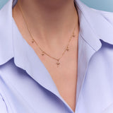 model wearing the gold star charm necklace