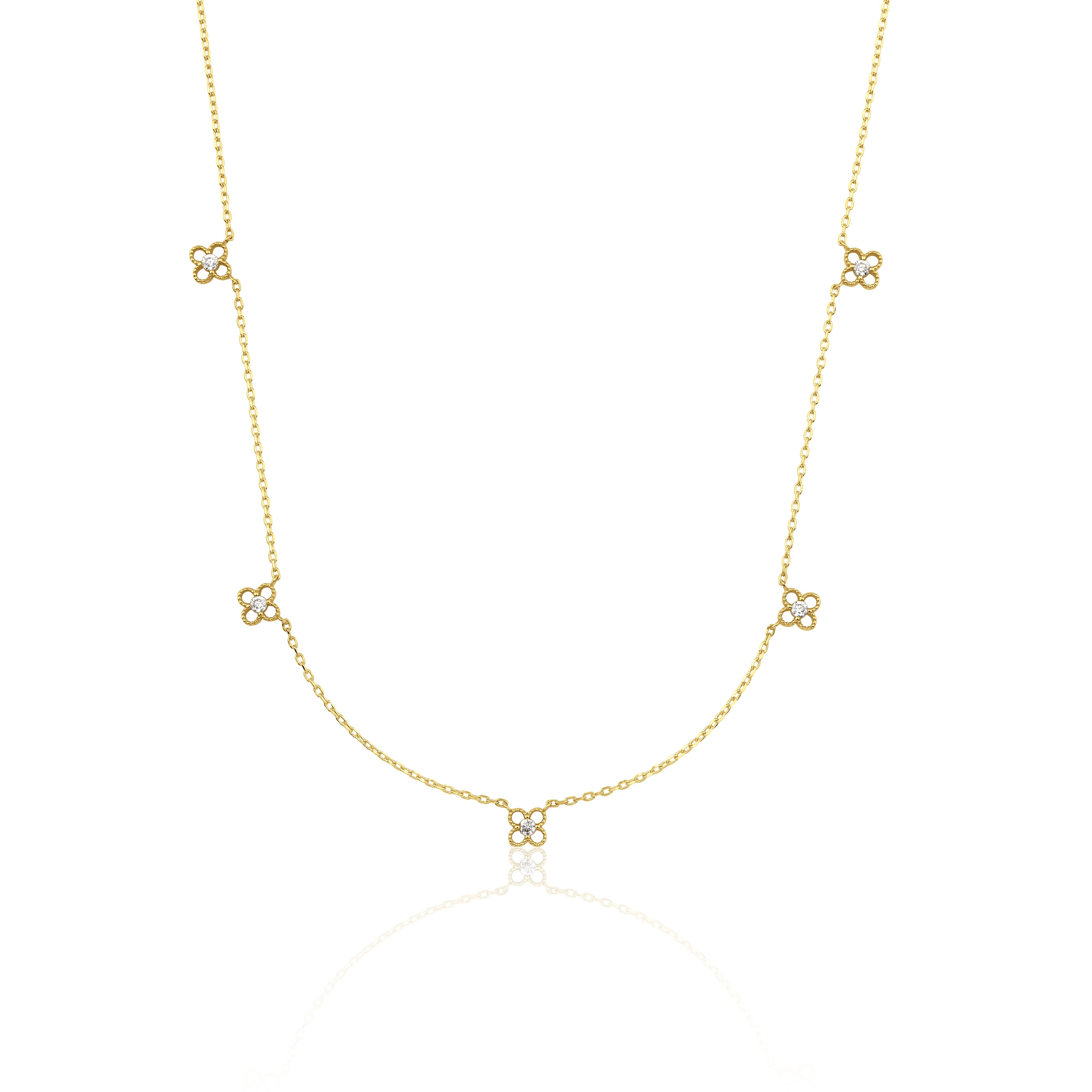 yellow gold four-petal flower station necklace on white background