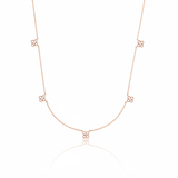 rose gold four-petal flower station necklace on white background