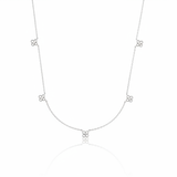 white gold four-petal flower station necklace on white background