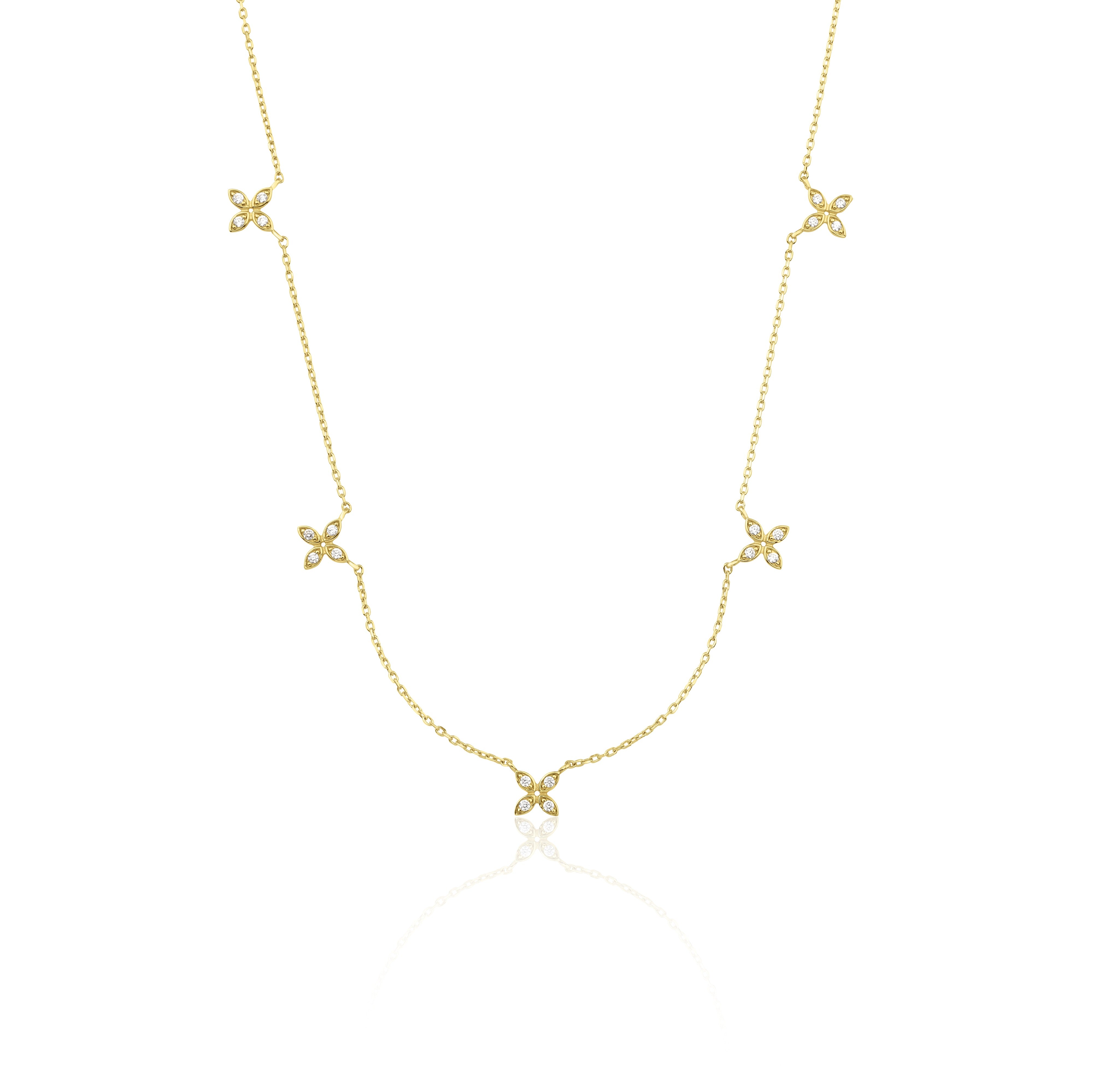 yellow gold floral station necklace on white background