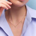 model wearing the gold floral station necklace