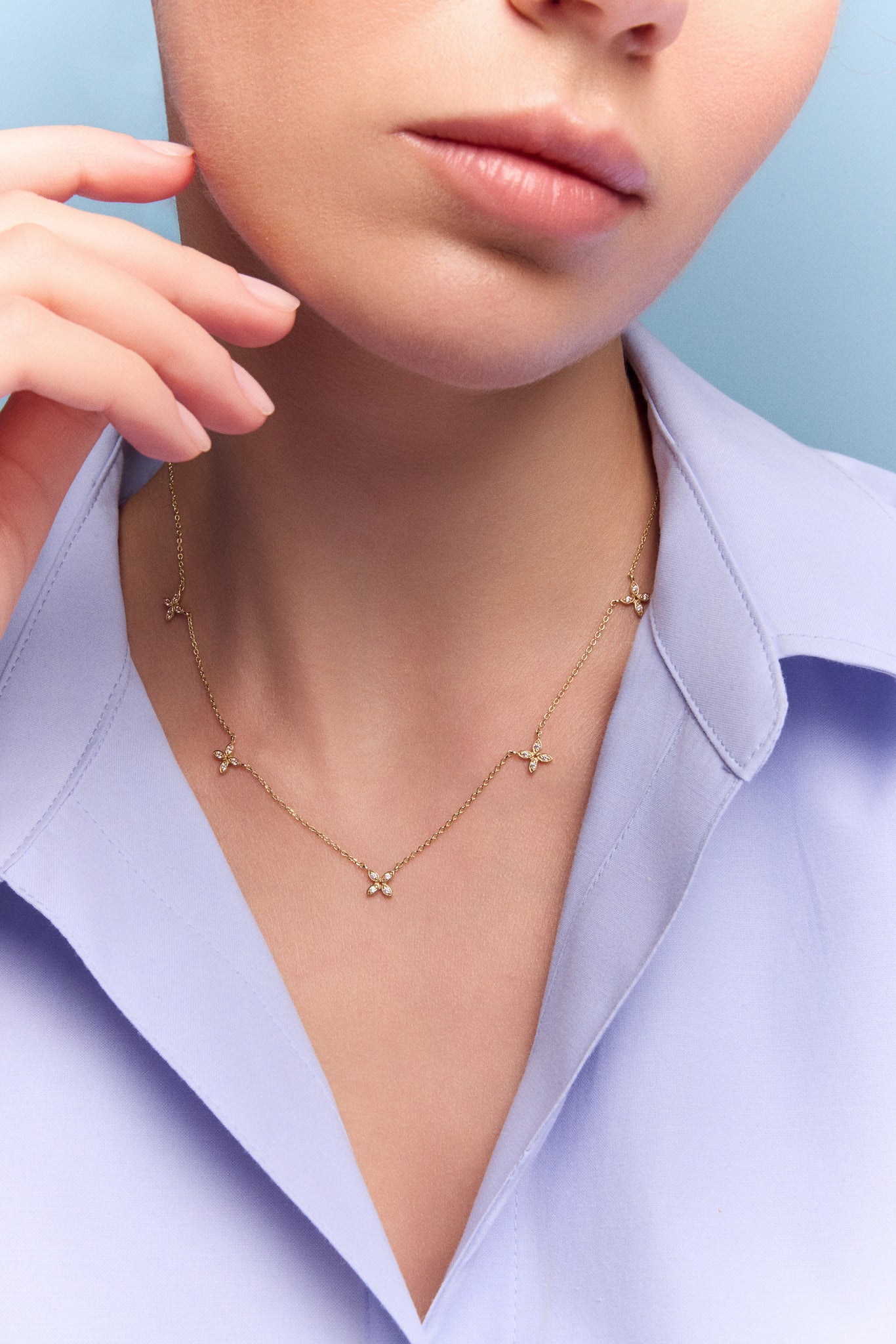 model wearing the gold floral station necklace
