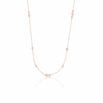 rose gold scattered stone necklace on white background