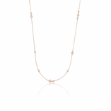 rose gold scattered stone necklace on white background