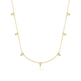 yellow gold beaded station necklace on white background
