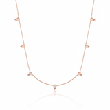 rose gold beaded station necklace on white background