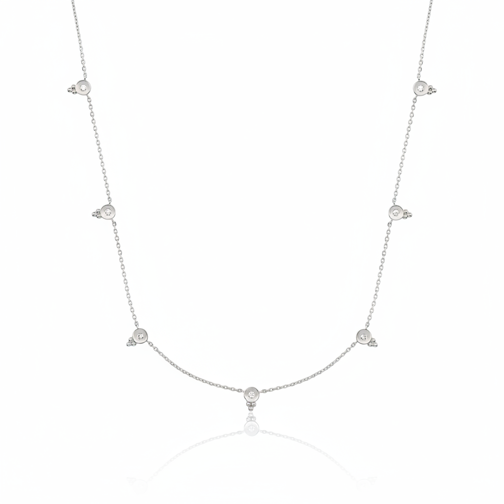 white gold beaded station necklace on white background
