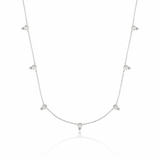 white gold beaded station necklace on white background