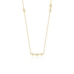 yellow gold clover station necklace on white background