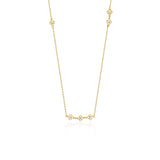 yellow gold clover station necklace on white background