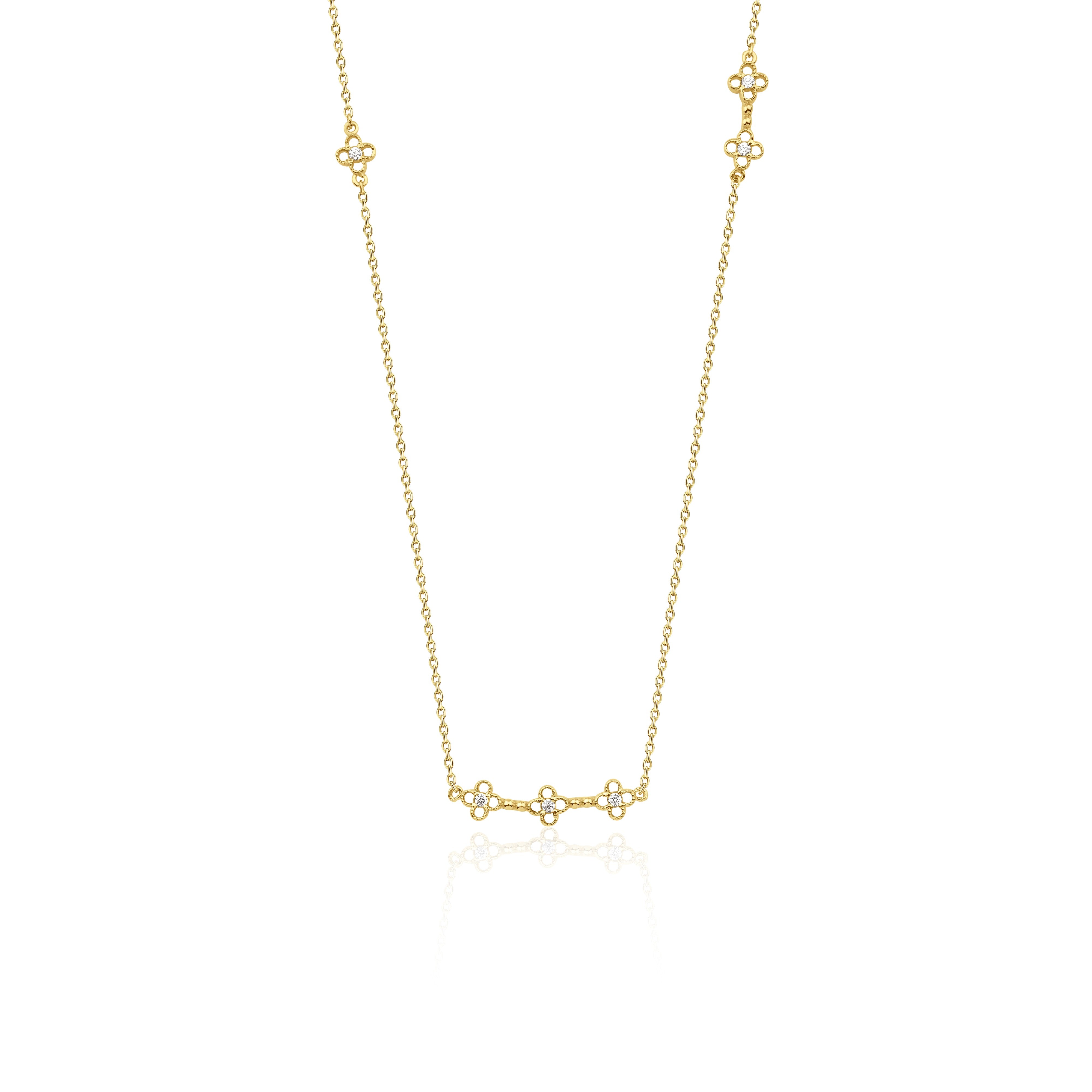 yellow gold clover station necklace on white background