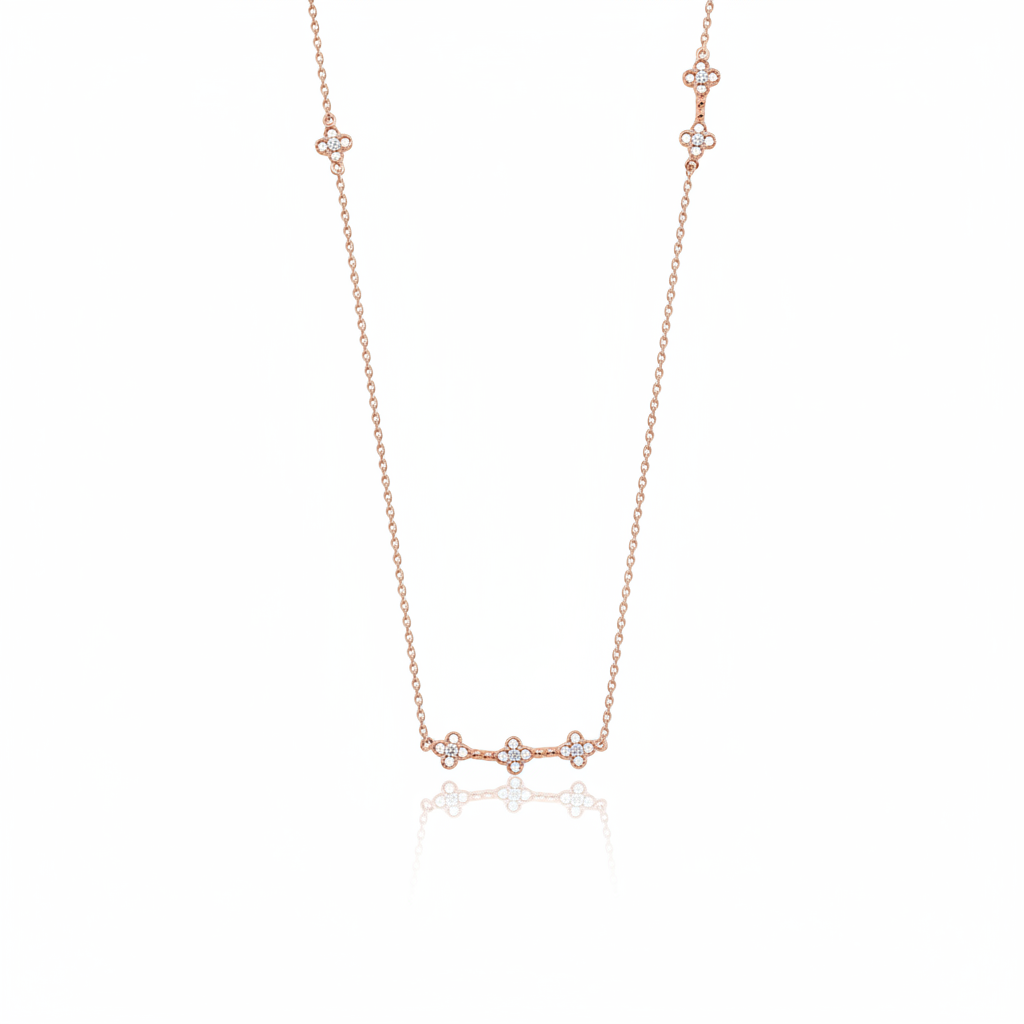 rose gold clover station necklace on white background
