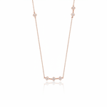 rose gold clover station necklace on white background