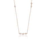 rose gold clover station necklace on white background