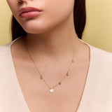 model wearing the gold square charm necklace
