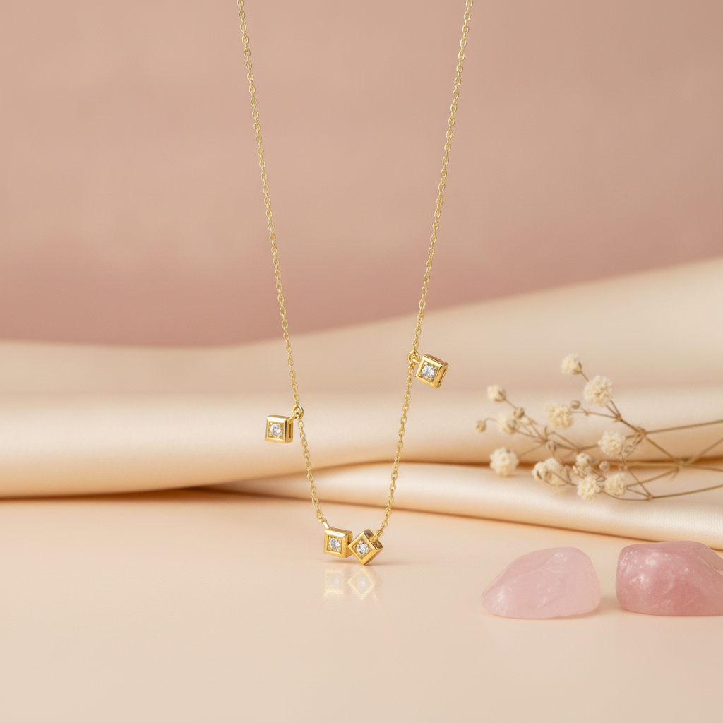 gold square frame necklace styled with pink quartz stones on a blush background