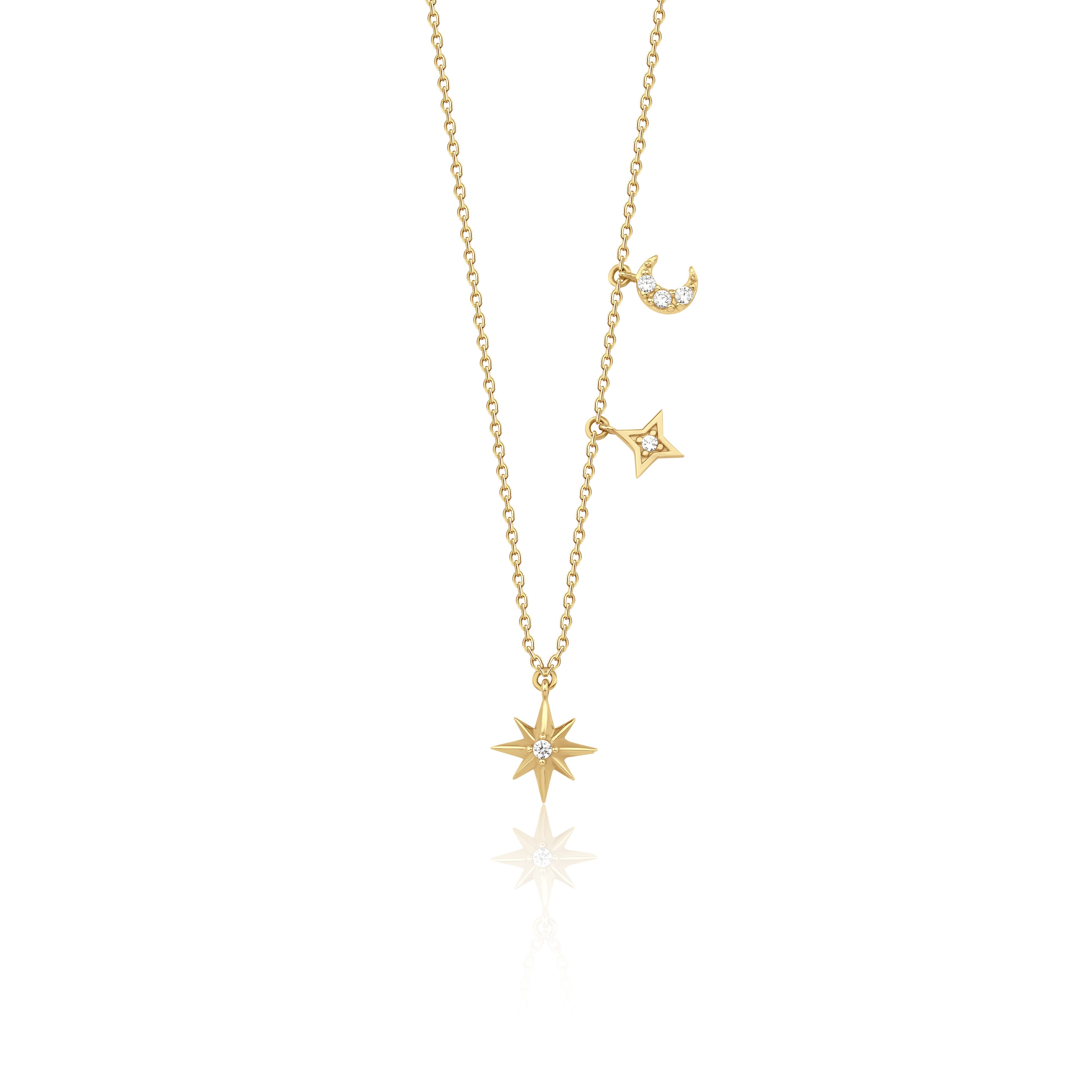 yellow gold moon and star pendant necklace on white background
