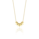 yellow gold sunburst pendant necklace on white background