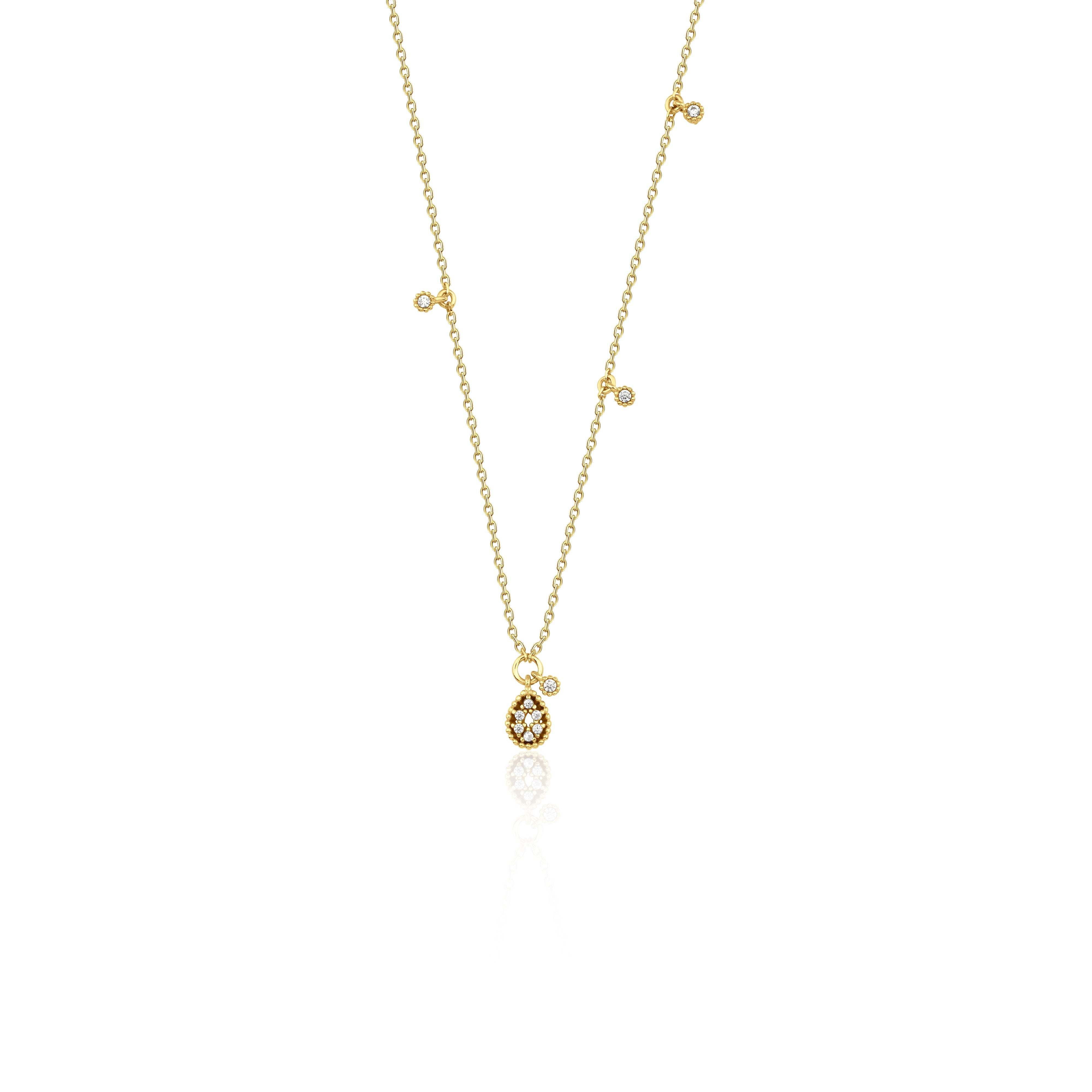 yellow gold teardrop pendant necklace on white background