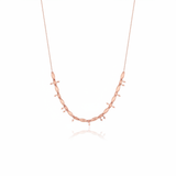rose gold arrow bead necklace on white background
