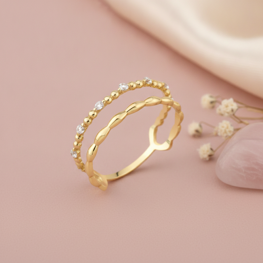 gold beaded and wave double-layer ring styled with dried flowers on a blush background