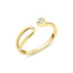yellow gold open bypass ring with a bezel-set round stone and a small accent stone on white background
