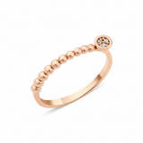 rose gold beaded ring with a round cluster of White CZ stones on white background