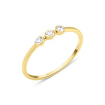 yellow gold slim ring with three bezel-set White CZ stones in a row on white background