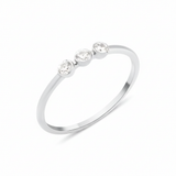 white gold slim ring with three bezel-set White CZ stones in a row on white background