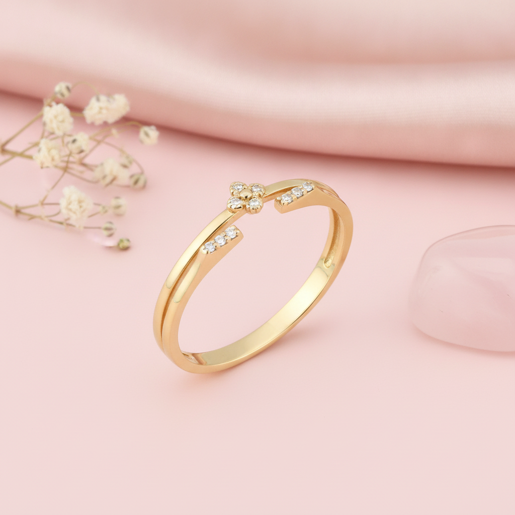 open gold ring with a four-petal blossom motif and pave White CZ stones, styled with dried flowers on a pink background