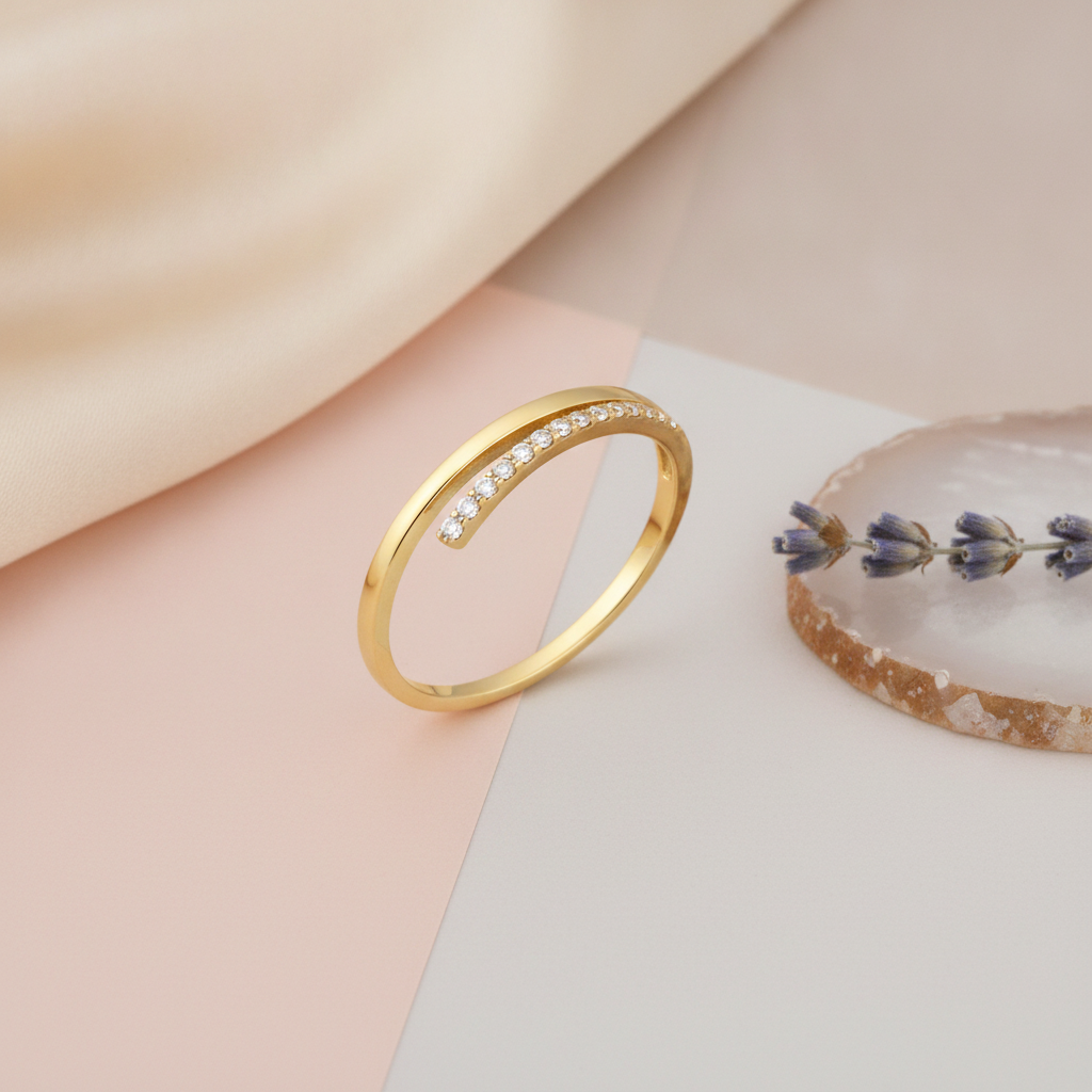 gold ring with an elevated row of White CZ stones on an asymmetrical band, styled with a dried lavender sprig on a two-tone background