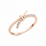 rose gold crossover ring with a smooth band and a pave White CZ band joined by a central bar on white background
