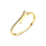 yellow gold open wrap ring with a diagonal pave bar and a single round stone on white background