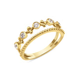 yellow gold double-band ring with a beaded strand, bezel-set stones, and polished gold spheres on white background