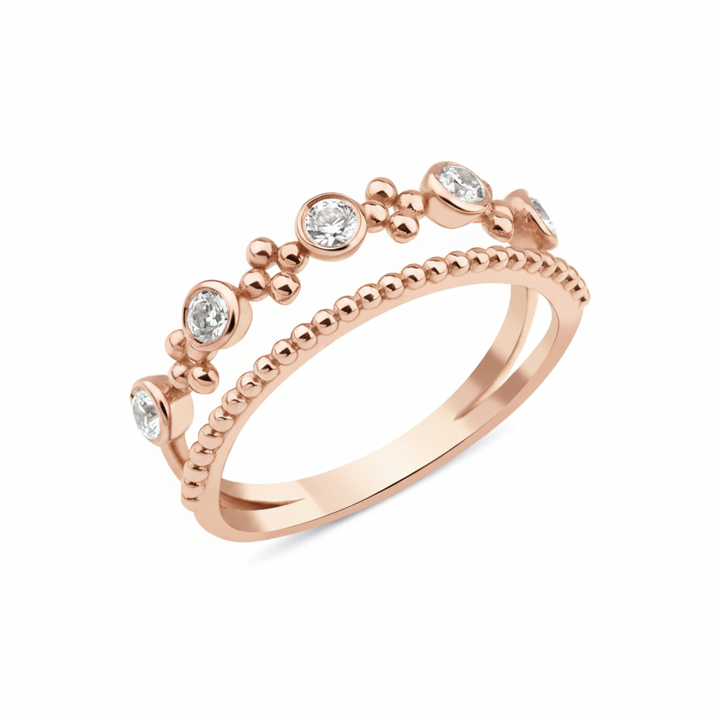 rose gold double-band ring with a beaded strand, bezel-set stones, and polished gold spheres on white background